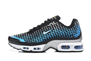Side profile of a black Nike Air Max Plus VII sneaker with blue-and-white patterned detailing and a visible cushioning sole.