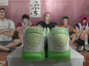 Rear view of light green and grey Jordan basketball sneakers with bright green midsoles.