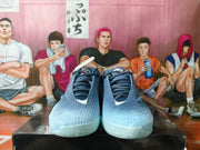 Front view of gray-blue Nike basketball shoes with lace-up closures