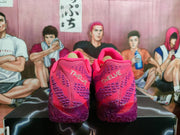 Rear view of pink and purple Nike basketball shoes showing patterned heels and textured purple outsoles
