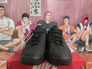 Front view of a pair of black Nike lace-up sneakers.