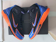 Pair of high-top shoes displayed from above with their blue and orange details