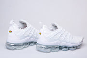 Pair of white Nike TN-2 sneakers in side profile, highlighting the sculpted upper and clear segmented soles.