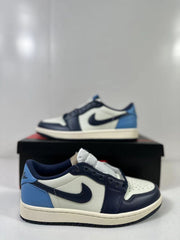 Close view of the low-top sneaker showing the side branding, blue heel, and layered upper.