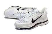 Pair of white Nike Pegasus Premium running shoes in an angled view.