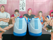 Rear view of light blue and white basketball sneakers with blue heel accents and a visible heel emblem.