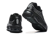 Rear and underside views of black sneakers with visible sole cushioning and tread.