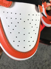 Close-up of the perforated white toe panel surrounded by orange overlays.