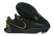 Black Nike basketball shoes with gold detailing and black outsoles.