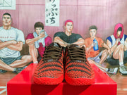 Front view of black and red Nike basketball sneakers displayed on a red box.