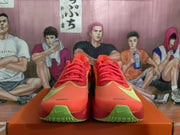 Front view showing the red toe boxes, yellow detailing, green forefoot accents, and lace-up construction.