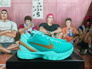 Side view of turquoise Nike Zoom basketball sneakers with textured uppers, gold-toned Swoosh branding, and a black display box.