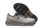On Cloudmonster 3 sneakers showing the gray and taupe color combination and outsole