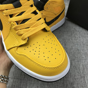 Close-up of the yellow perforated toe box, laces, and stitching.