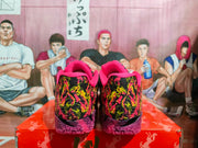 Rear view of the pair showing the colorful patterned heel panels, pink collars, and purple textured soles.