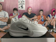 Side profile of a gray Nike KD sneaker showing the black Swoosh accent, KD marking, sculpted side panel, and textured upper.