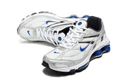 Pair of silver and white Nike Shox Ride 2 sneakers with blue accents, shown at an angle.
