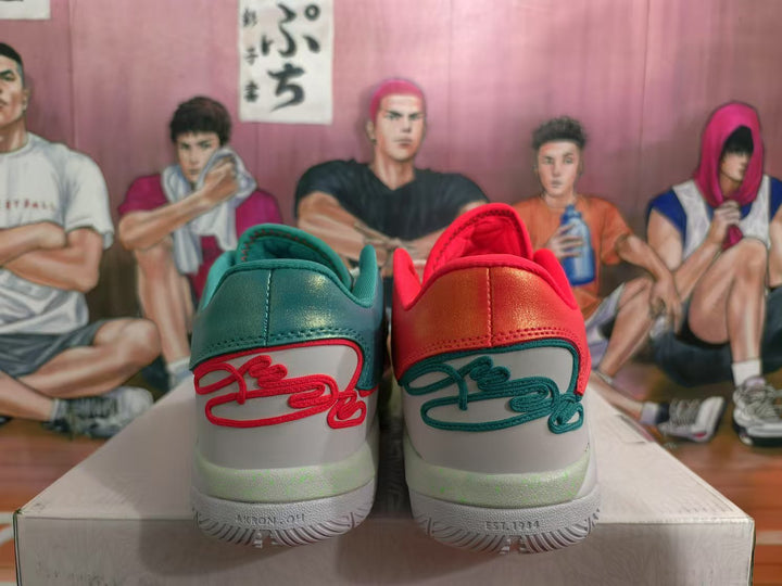 Rear view of red and teal Nike sneakers showing contrasting heel panels, decorative stitching and white midsoles.