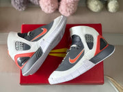 Top-down rear three-quarter view highlighting the heel structure, red accents, and white outsole.
