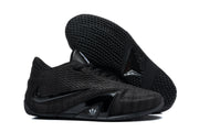 Black Nike Metcon shoes with one shoe turned over to show its patterned outsole.