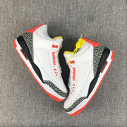 Pair of white Jordan 3 sneakers shown from above with red, yellow, and black details.