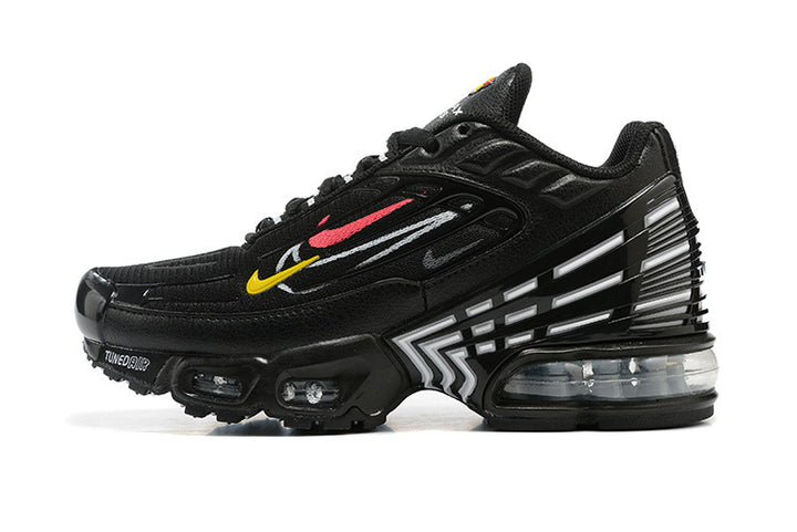 Side view of a black Nike sneaker with colorful side graphics, geometric heel details and visible sole cushioning.