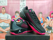 Angled view of the pair showing the black and grey uppers, red-pink accents, padded collars, and textured outsoles.