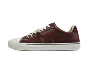 Side view of a burgundy low-top sneaker with a white sole