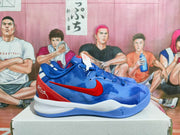 Side view showing the blue upper, red Nike Swoosh, white midsole, and blue outsole.
