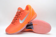 Bright orange Nike basketball sneaker shown at an angled side view with a silver Swoosh and translucent outsole.