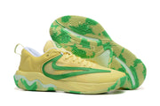 Yellow basketball shoe with green accents and patterned outsole
