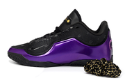 Side profile of a black and purple Nike LeBron 23 basketball shoe with a glossy purple panel.
