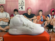 Side view of a white and silver Nike high-top basketball shoe with Zoom branding