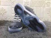 Air Jordan 11 high-top sneakers shown from the front and outsole, with a cool grey upper and translucent soles.