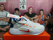 Side profile of a white Nike Zoom basketball shoe with blue and orange accents