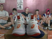 Rear view of white ASICS METARISE sneakers with orange outsole accents and ASICS heel logos.