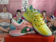 The pink and yellow sneakers displayed together, with green accents on the yellow shoe.