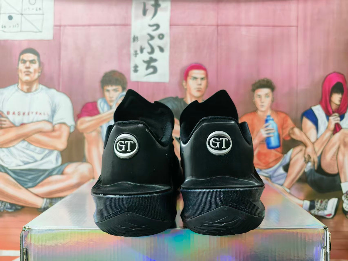 Rear view of black Nike GT basketball sneakers showing the GT heel emblems and patterned outsoles.