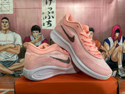 Pair of pink and white basketball shoes shown from the side