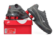 Gray and red Nike Shox Ride 2 sneakers displayed with a red shoe box; the label shows sample sizes 8.5 and 10.