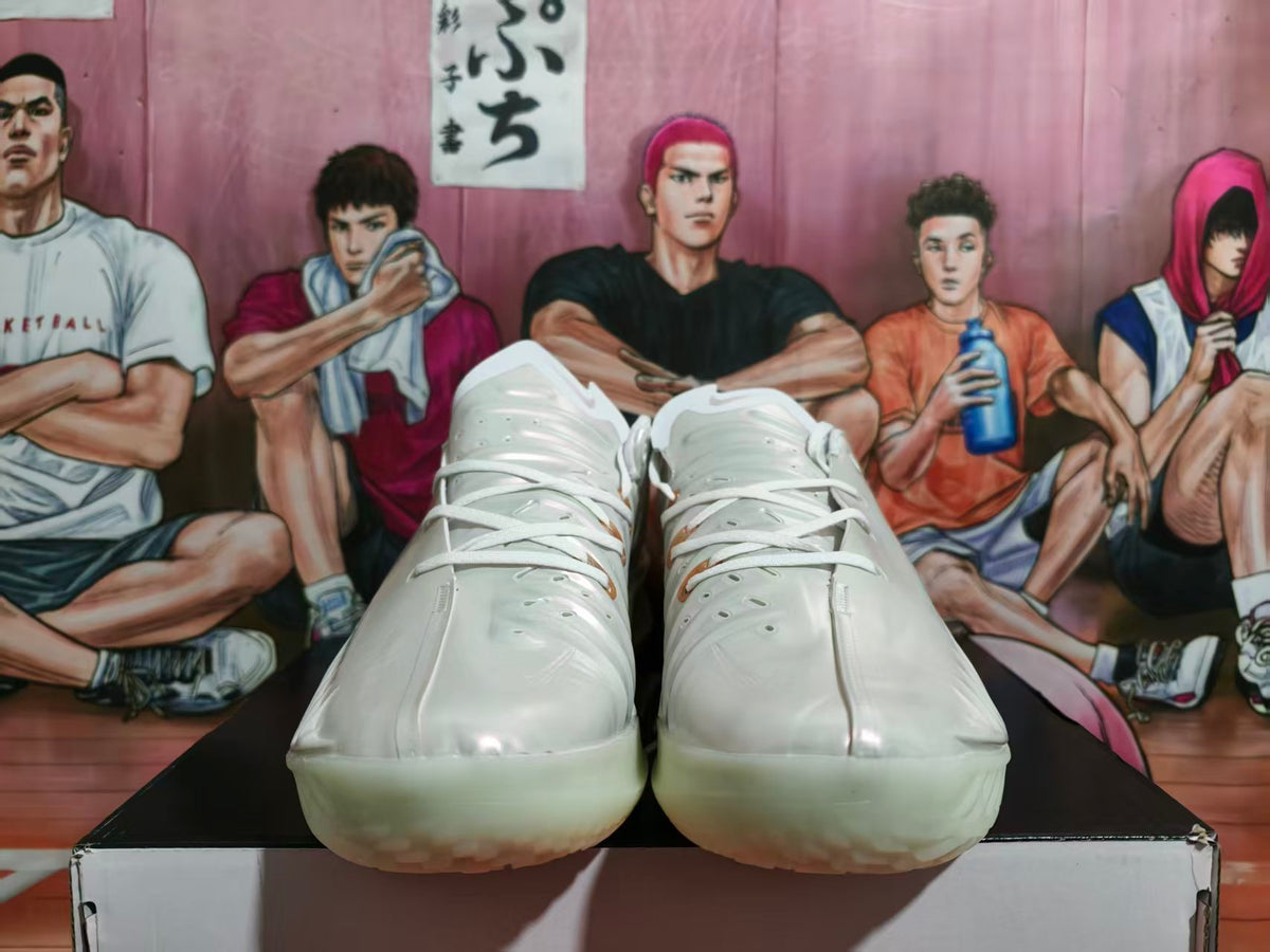Front view of white Nike basketball shoes with a glossy finish and pale translucent-looking soles