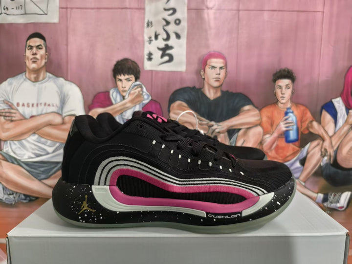 Side view of black Jordan basketball sneakers with pink and light-colored layered side accents on a shoe box.