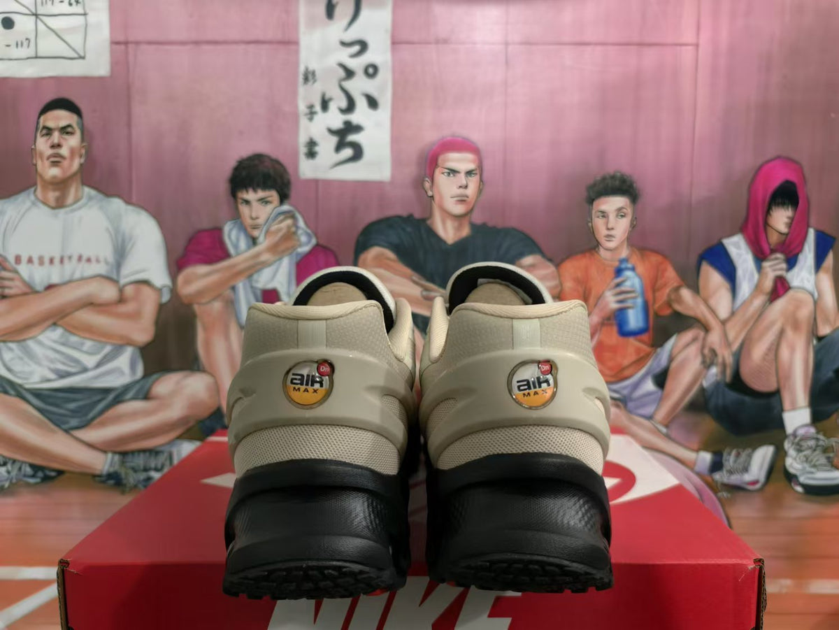 Rear view of beige and black Nike Air Max sneakers showing heel branding and black outsole sections.