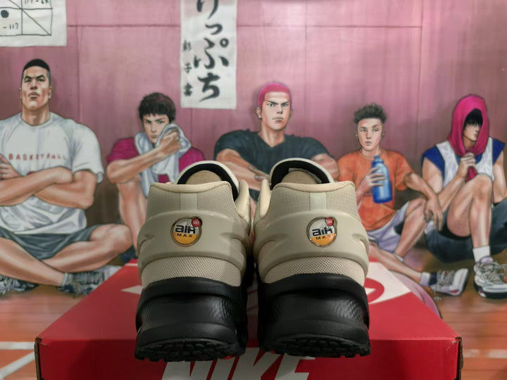 Rear view of beige and black Nike Air Max sneakers showing heel branding and black outsole sections.
