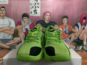 Front view of green basketball sneakers with black toe accents, textured laces, and matching green uppers.