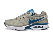 Side view of a gray Nike Air Max sneaker with blue Swoosh and a visible heel air unit.