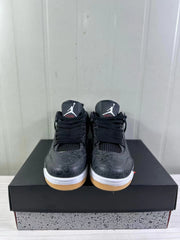 Front view of black Air Jordan 4 sneakers with black laces, Jordan tongue logos, tonal upper graphics, white midsoles, and gum-colored toe areas.