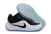 Side view of a black and white Nike sneaker with a black Swoosh and a translucent light-blue outsole.