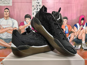 Angled view of paired black Jordan basketball sneakers displaying the upper, laces, heel accents, and outsole.