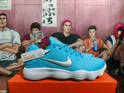 Side view of a blue Nike basketball shoe with a silver-tone Swoosh